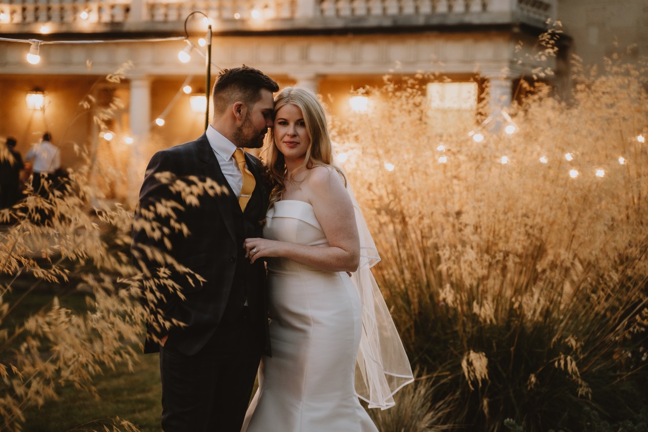 Bridge and Groom surrounded by fairy lights